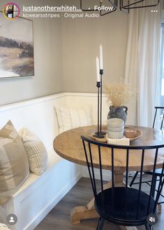 a table and chairs in a room with white walls