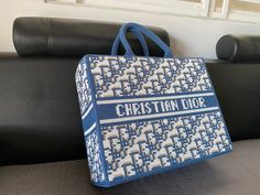 a blue and white bag sitting on top of a couch