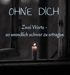 a lit candle sitting in front of a window with the words ohne dich on it