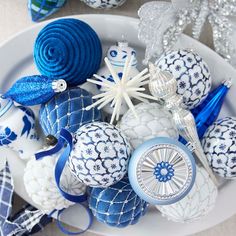 blue and white ornaments are on a plate