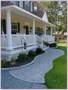 a house with white pillars and green shutters on the front porch is shown in this image