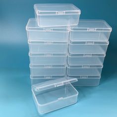 several clear plastic storage containers stacked on top of each other in front of a blue background