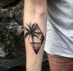 a man with a tattoo on his arm that has a palm tree in the shape of a diamond