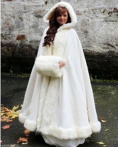 a woman is dressed in a white fur coat