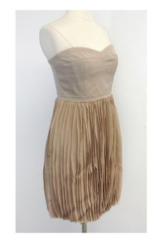 Size 10 Angel strapless pleated skirt dress in pumice Retails for $388.00 Body 70% Polyester 28% Rayon 2% Spandex Contrast 100% Polyester Lining 100% Polyester Concealed back zip and clasp Bone in bodice Silicone strip inside bust Has original tag Across top of bust 17" Under bust 15.25" Waist 29" Hips 41" Total length 28.5" Fitted Knee-length Strapless Dress With Lining, Strapless Party Dress With Pleated Waist, Summer Pleated Strapless Mini Dress, Fitted Pleated Strapless Mini Dress, Fitted A-line Strapless Dress With Pleated Bodice, Formal Strapless Dress With Pleated Waist, Fitted Pleated Mini Dress With Sweetheart Neckline, Knee-length Lined Strapless Dress For Date Night, Formal Beige Pleated Dress