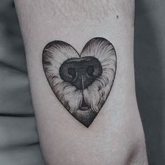 a black and white tattoo of a dog's face in the shape of a heart