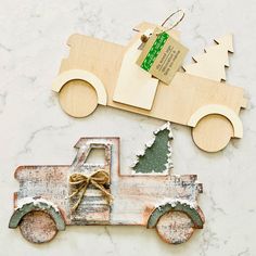 a wooden ornament with a truck and tree on it