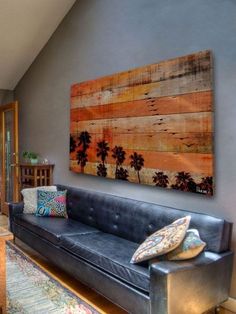 a living room filled with furniture and a large painting on the wall above it's couch