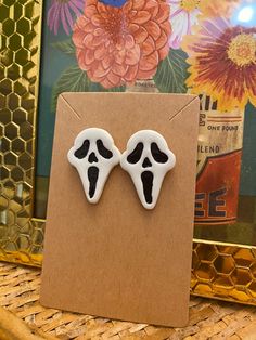 👻 Minimalist Ghostface Post Earrings - Handmade Halloween Spooky Jewelry 🎃 These handcrafted Minimalist Ghostface Post Earrings are a perfect blend of spooky chic and goblincore vibes. Inspired by one of my favorite Halloween scares, each earring is carefully molded from Sculpey Premo clay, detailed with handpainted black accents, and sealed with a Sculpey gloss glaze for lasting shine. Measuring at approximately 1.2" in length and 0.85" in width, these lightweight earrings are perfect for add Spooky Jewelry, Spooky Chic, Ghost Face, Halloween Celebration, Lightweight Earrings, Black Accents, Light Weight Earrings, Minimalist Earrings, Halloween Fun