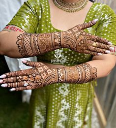 a woman with henna tattoos on her hands