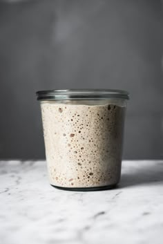 a glass jar filled with oatmeal sitting on top of a counter