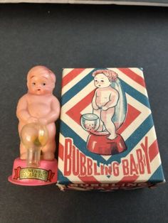 there is a small toy baby sitting next to a box that says bubbleling baby