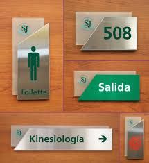 several different types of restroom signs on wood