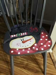 a chair with a snowman painted on it