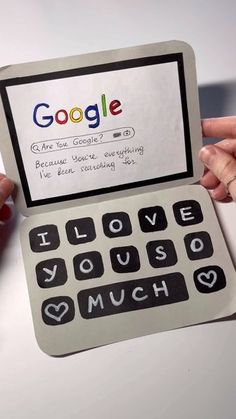 two hands holding an open laptop computer with google on the screen and i love you so much written on it