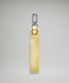 a metal keychain with a yellow tag attached to it that says, millennium