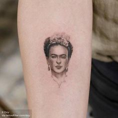 a woman's portrait tattoo on the arm