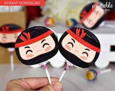 two lollipops with faces painted on them