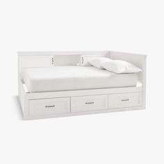 a white bed with two drawers underneath it