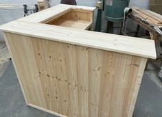 an unfinished wooden counter being built in a shop