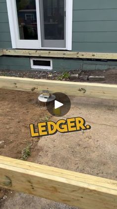 a wooden deck with the word ledger on it in front of a house that is being built