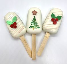 three pops decorated like christmas trees on wooden sticks