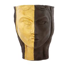 a yellow and black face vase sitting next to each other