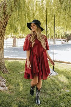 Introducing the Isabelle Asymmetrical Mini Dress in Berry - a fun and flirty addition to your wardrobe. Featuring an asymmetrical pattern, this flowy dress exudes a pretty and unique vibe. Designed in a beautiful berry red and a flattering babydoll style, it's the perfect dress for any occasion. Paired with THE CONTRAST COWBOY BOOTS IN BLACK Asymmetrical detail Puff Sleeve Button closure Mini length Lined Self 100% cotton, Lining 100% cotton Dress is true to size. Small (0-2), Medium (4-6), Larg Women’s Western Dress Outfits, Cowboy Boots With Dress, Flowy Red Bohemian Mini Dress, Western Babydoll Dress, Spring Bohemian A-line Mini Dress, Red Bohemian V-neck Mini Dress, Summer Goddess, Western Dresses For Women, Babydoll Style