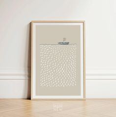 an art print with a boat floating in the ocean on it's side, against a white wall