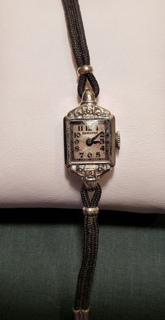 This is a stunning, dainty, Hamilton ladies wrist watch from the 1930's. It has a solid 14KT white gold bezel and case, the bezel also has two beautiful diamonds. The watch has the original gold plated band. It has 17 jewels. The hands move and the watch winds but it is not currently ticking. It will need to be serviced if planning to wear as a timepiece.  Very special vintage watch in wonderful vintage condition. I love finding and restoring, to the best of my ability, antique and vintage items Luxury Antique Rectangular Watch, Luxury Vintage Evening Watches, Luxury Vintage Jewelry And Watches With Polished Finish, Luxury Antique Watch Accessories, Luxury Victorian Engraved Watch, Cheap Vintage Watch Accessories For Women, Luxury Vintage Watch Bracelet Strap, Vintage Watch Chaika, Luxury Antique Self-winding Watch