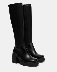 The BERKLEIGH square toe knee boot gives you a sleek and defined silhouette with a stretch fabric construction and platform sole with a block heel. Square toe platform block heel knee boot Side zipper closure Stretch fabric 3.25 inch heel height 1 inch platform Size 6 measurements: 13.1 inch top-shaft circumference, 11.9 inch mid-shaft circumference, 15 inch shaft height Size 8 measurements: 13.5 inch top-shaft circumference, 12.3 inch mid-shaft circumference, 16 inch shaft height Size 10 measur Black Boots Knee, Steve Madden Store, Black Knee High Boots, Platform Block Heels, Leather Socks, Knee Boot, Black Knees, Boots Knee, Platform Boots