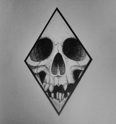 a black and white photo of a skull in a diamond - shaped frame on a wall