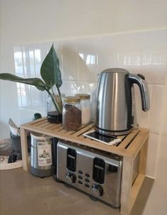 a toaster and coffee maker on a wooden shelf