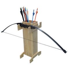 an arrow and bow in a wooden box with arrows sticking out of the back end