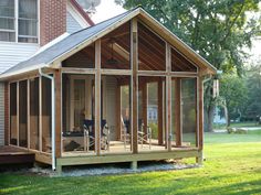 a screened in porch on the side of a house