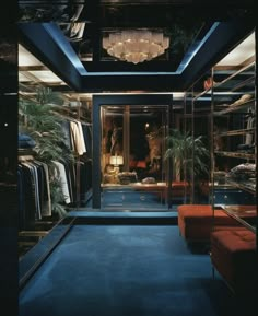 the closet is full of clothes and other items for sale at night time, with blue carpeting