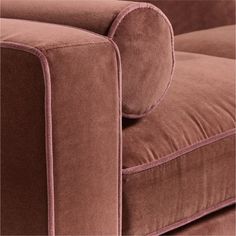 a close up view of the back end of a couch with pink velvet on it