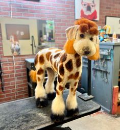 a stuffed giraffe standing on top of a table