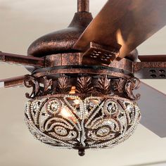 a ceiling fan with a chandelier hanging from it