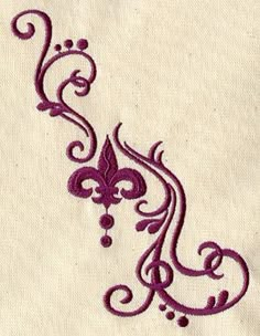 an embroidered design on a piece of cloth with purple thread in the middle and small flowers at the bottom