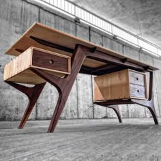 a wooden desk with two drawers on it's legs and an open drawer underneath