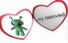 a green stuffed animal next to a red heart with the word my beloved on it