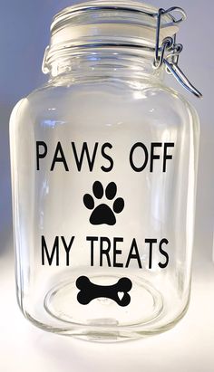 a glass jar that says paws off my treats