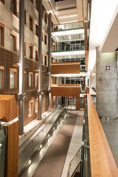 the inside of an office building with wooden and glass balconies on each floor