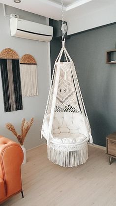 a white hanging chair in a living room