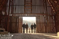 three people standing in an open barn door