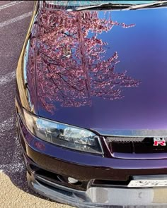 the front end of a purple car parked in a parking lot