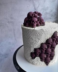 there is a white cake with purple skulls on it