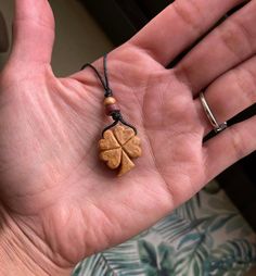 Shamrock Carved from Avocado Pit. -All pendants when dry and hard as wood are then sanded, treated with olive  oil & sealed. All colors are natural of the avocado stone.  -The pendants come with about 3 ft of hemp cord for you to adjust desired necklace length. -Avocado stones have been carried to promote love, beauty and aphrodisiac qualities since the 8th century!  -I try to make my packages as recycled and plastic free as possible. Vegan friendly. *Thank you for stopping by! Avocado Pit Carving, Avocado Carving, Wood Whittling, Avocado Jewelry, Avocado Pit, Shamrock Necklace, Collar Hippie, Profitable Crafts, Avocado Art