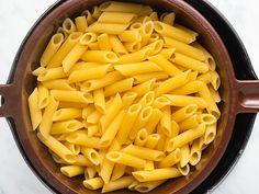 a pot filled with pasta on top of a table